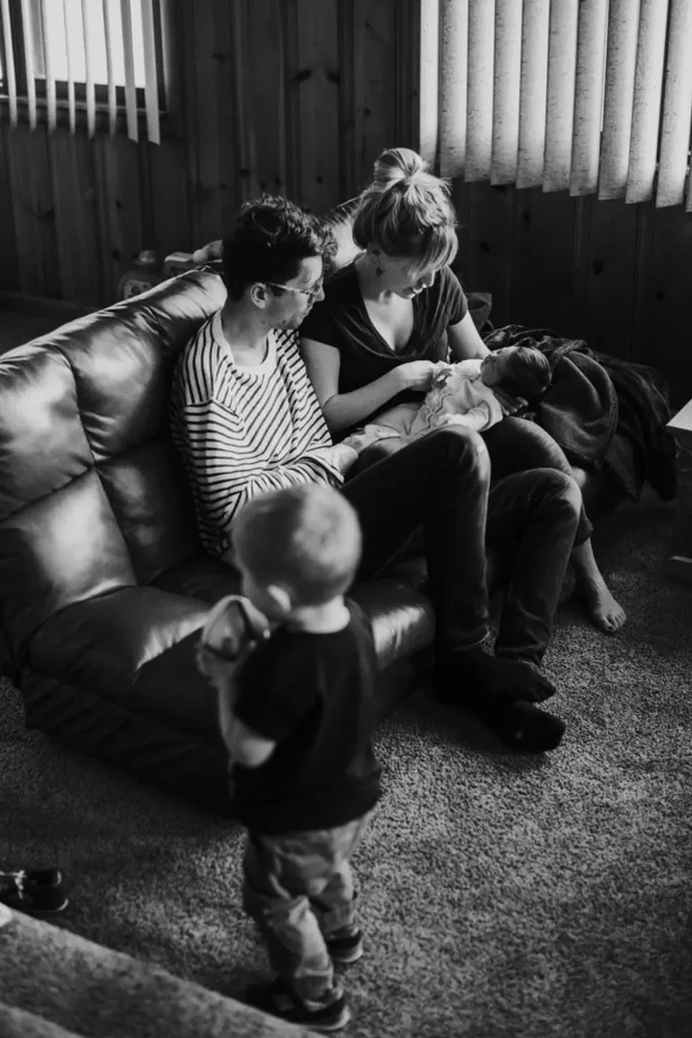 Photo en noir et blanc d'une famille dans un salon | Photo : Unsplash